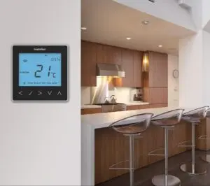 Underfloor heating thermostat fixed on kitchen wall.